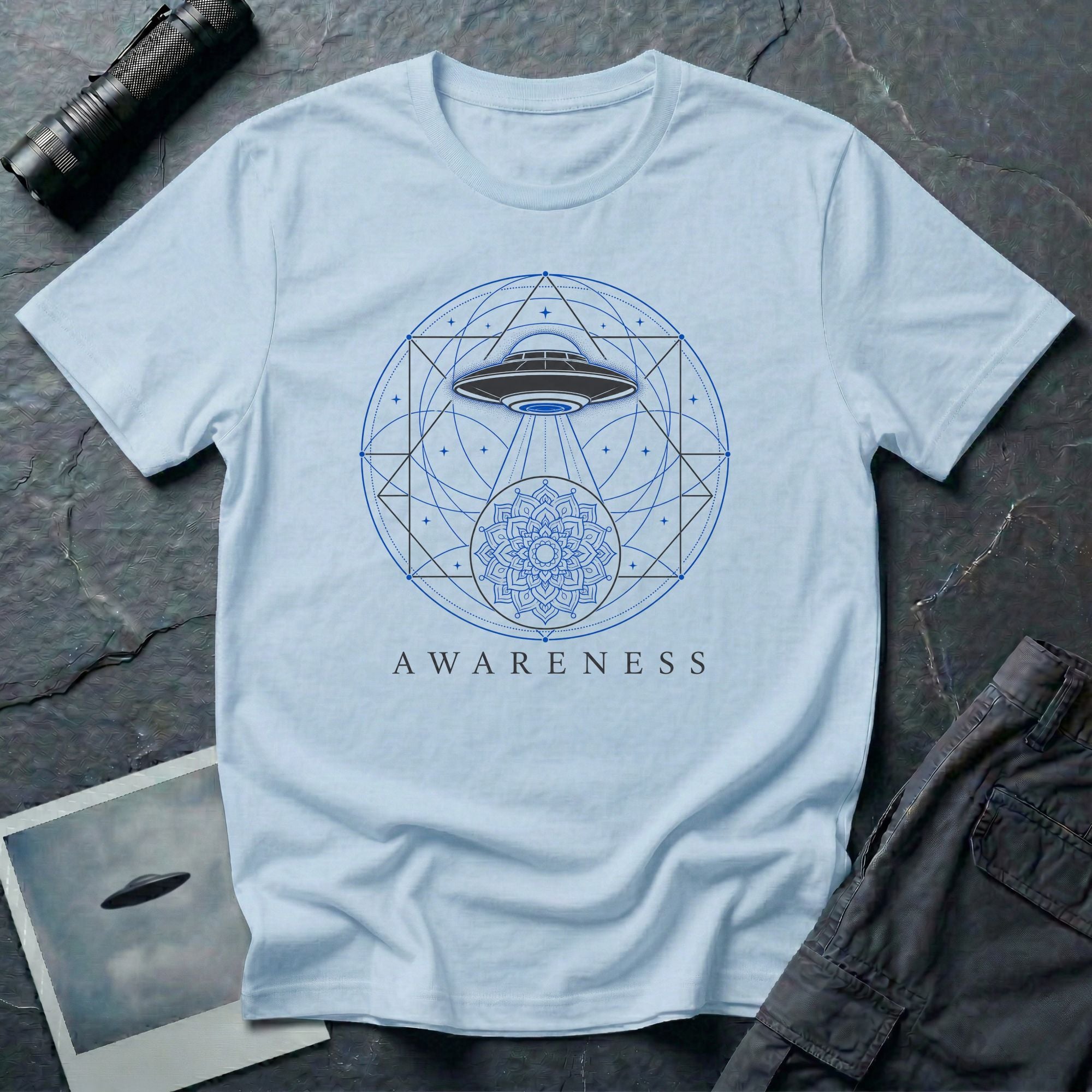 Sacred geometry UFO t-shirt, craft with light beam descending through geometric circles and triangles into a mandala, the word Awareness below, light blue