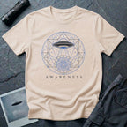 Sacred geometry UFO t-shirt, craft with light beam descending through geometric circles and triangles into a mandala, the word Awareness below, natural