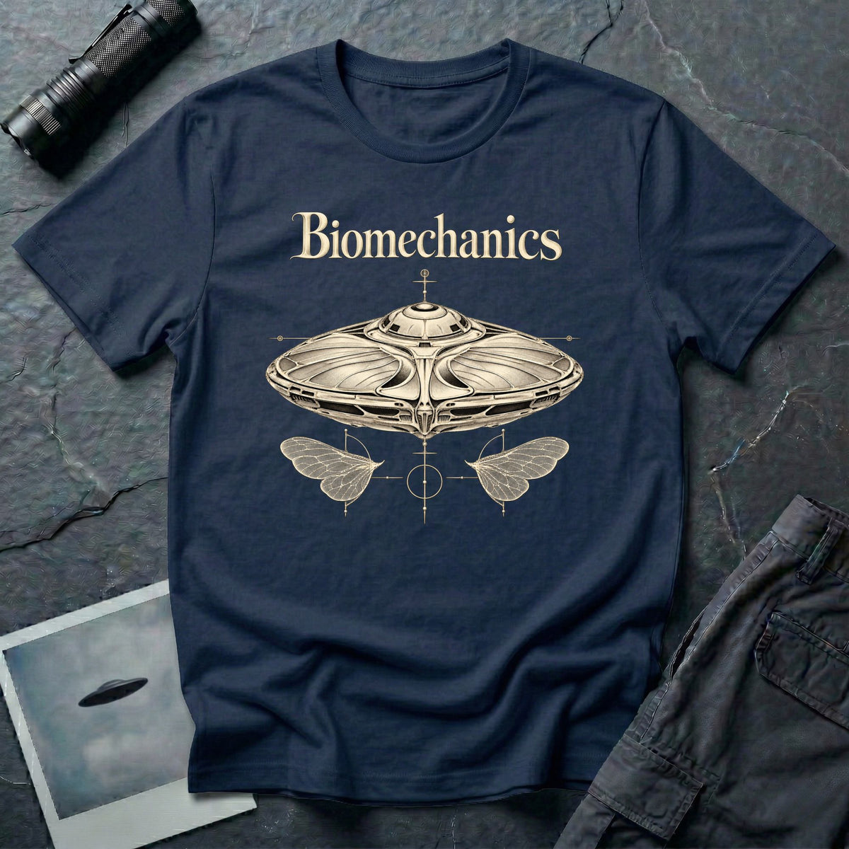 Biomechanics UFO T-shirt with an organic flying saucer, symmetrical insect wings and Victorian specimen-style ivory engraving on navy blue tee