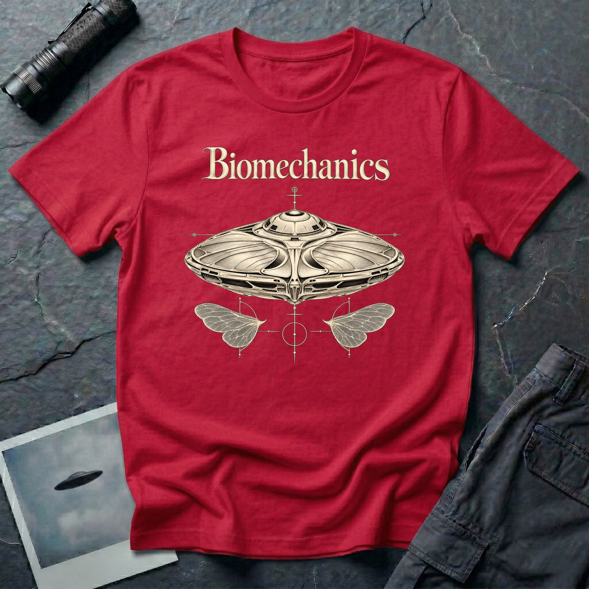 Biomechanics UFO T-shirt with an organic flying saucer, symmetrical insect wings and Victorian specimen-style ivory engraving on red tee