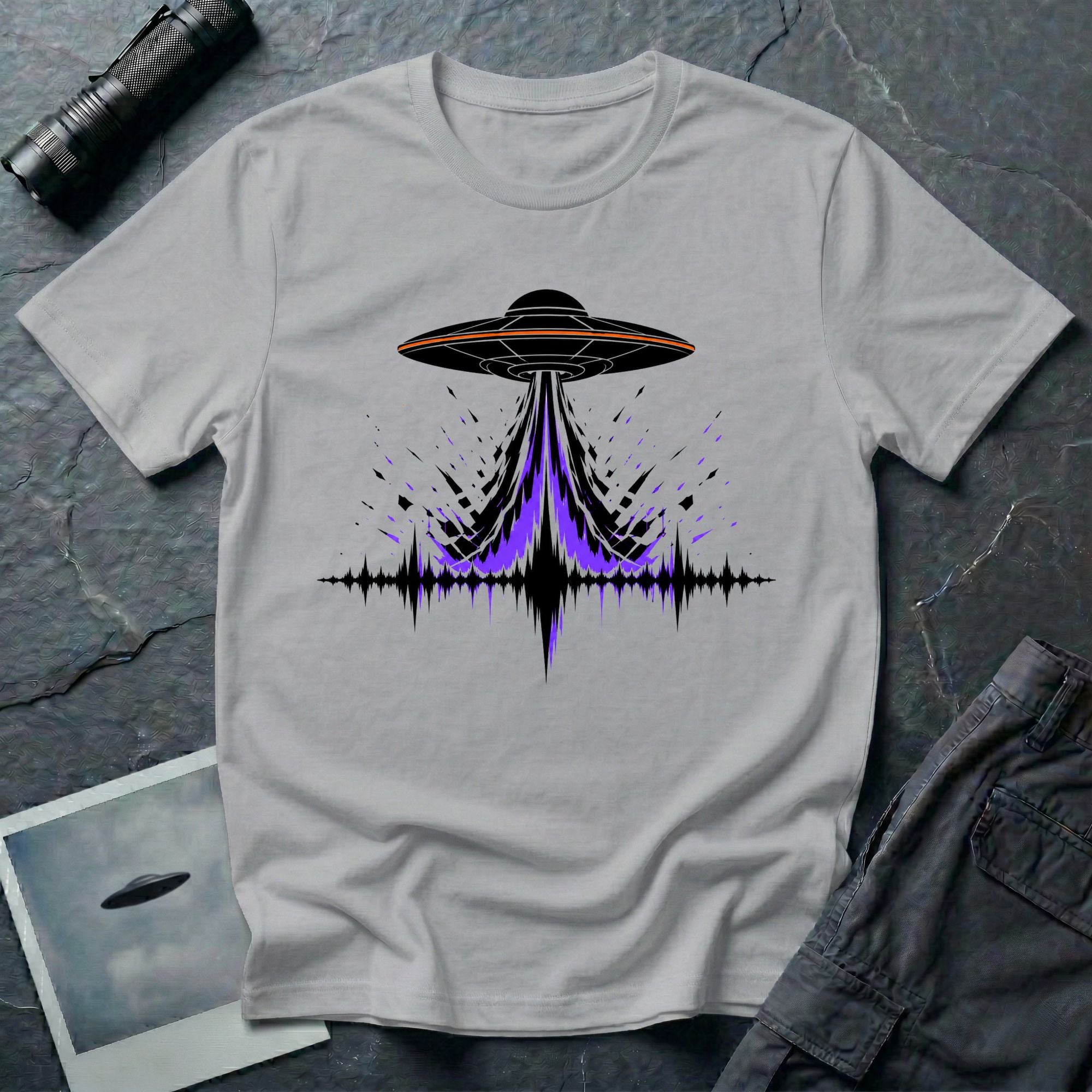 Carrier Wave UFO graphic t-shirt with black saucer emitting a purple and black audio frequency waveform, grey