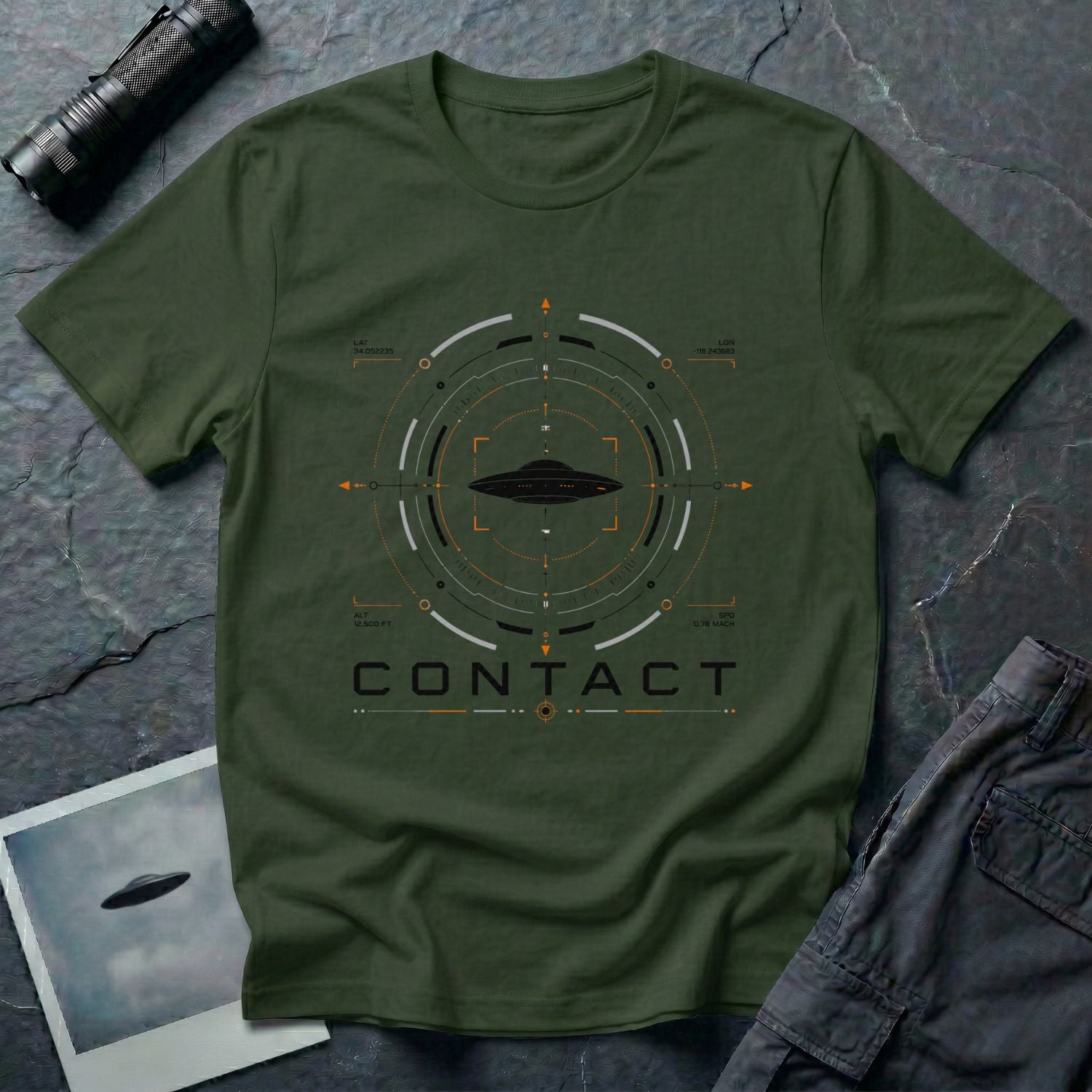 Military green UAP t-shirt with a flying saucer inside a military radar targeting interface showing Los Angeles coordinates, altitude, and speed data with the word CONTACT