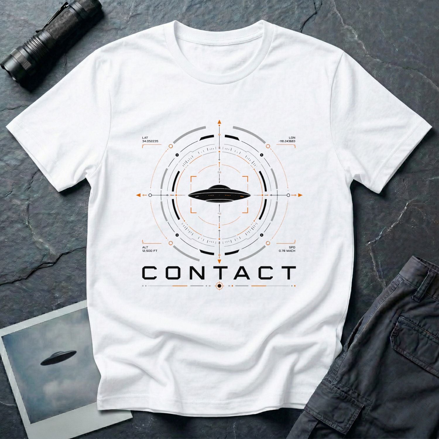 White UAP t-shirt with a flying saucer inside a military radar targeting interface showing Los Angeles coordinates, altitude, and speed data with the word CONTACT
