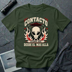 Green t-shirt with vintage rock poster style alien head, UFO, and Spanish text reading Contacto Estamos Aquí Desde El Más Allá