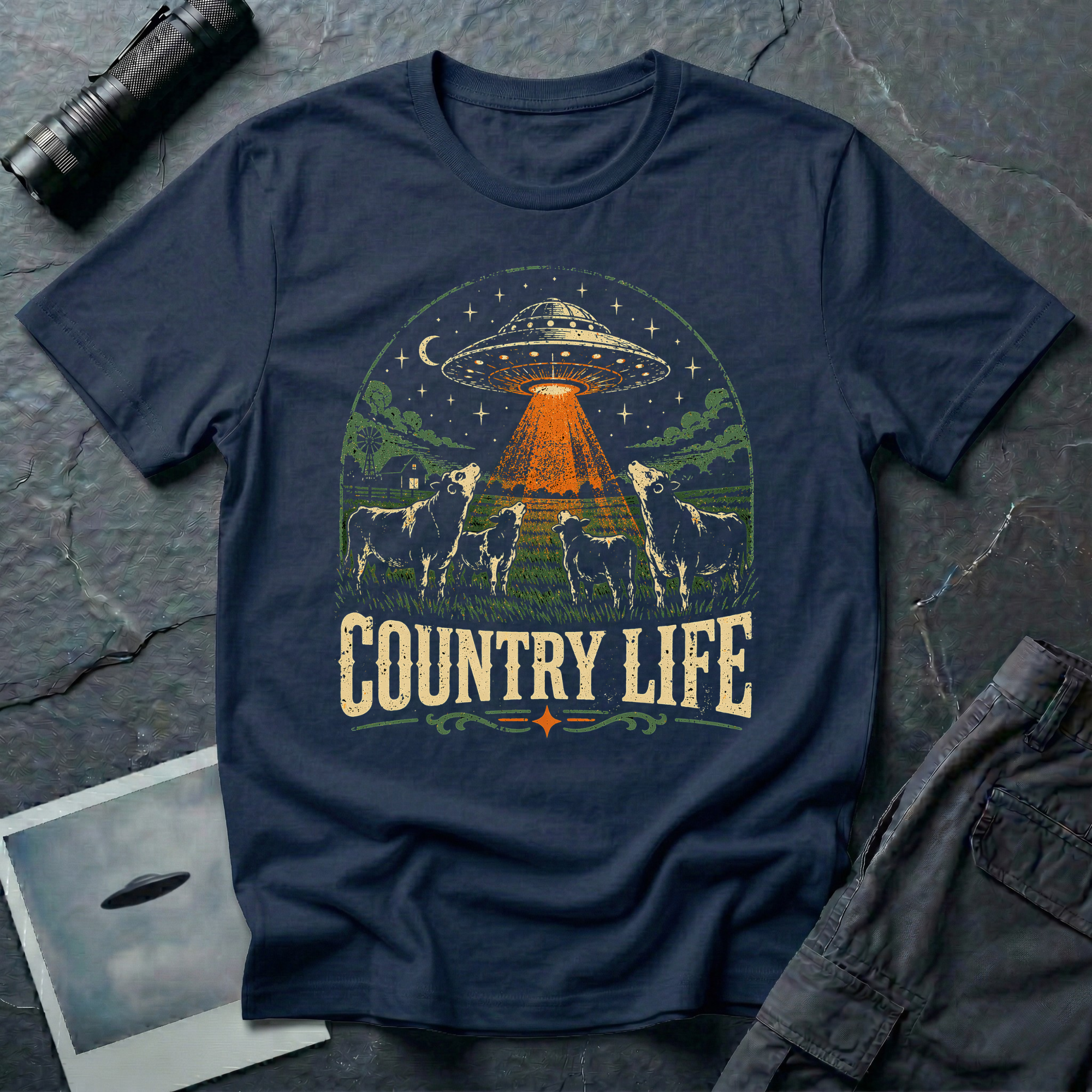 Country Life cow UFO t-shirt — flying saucer over farmyard with cattle on navy unisex cotton tee