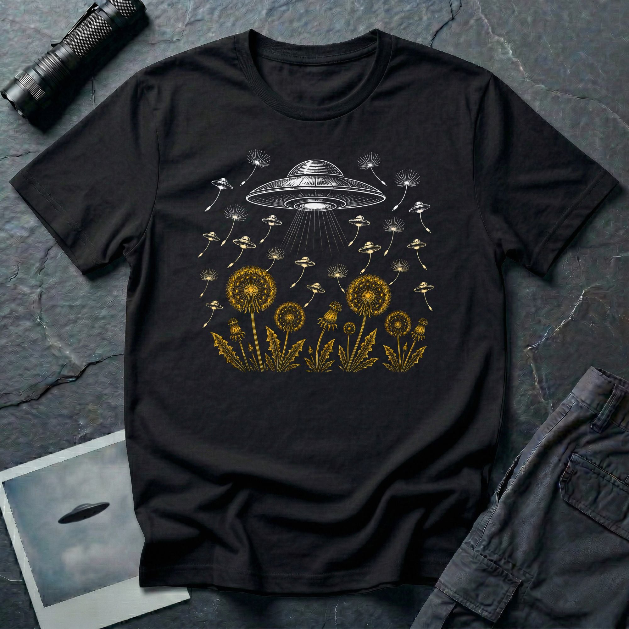 Dandelion UFO Fleet t-shirt with gold botanical dandelions releasing seed saucers toward a white mothership, black tee