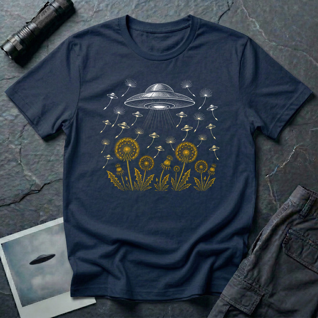 Dandelion UFO Fleet t-shirt with gold botanical dandelions releasing seed saucers toward a white mothership, navy blue tee