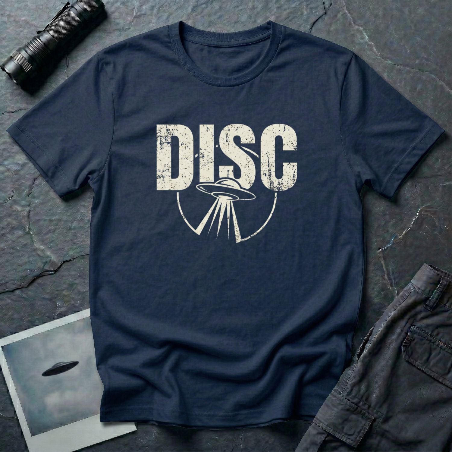 Navy blue vintage UFO t-shirt with distressed block letters spelling DISC above a flying saucer with tractor beam in white
