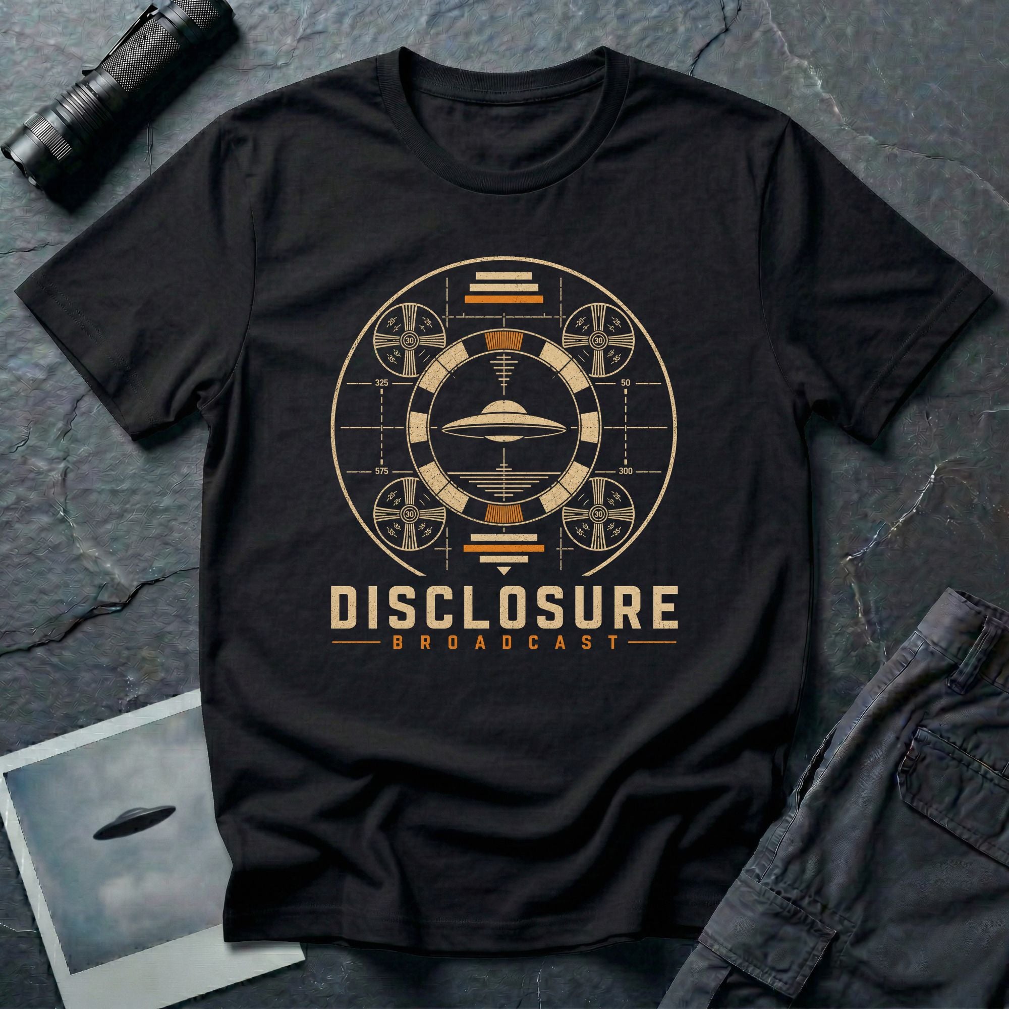 Black UFO disclosure t-shirt with a flying saucer inside a circular vintage broadcast radar array with orange accents and the words DISCLOSURE BROADCAST