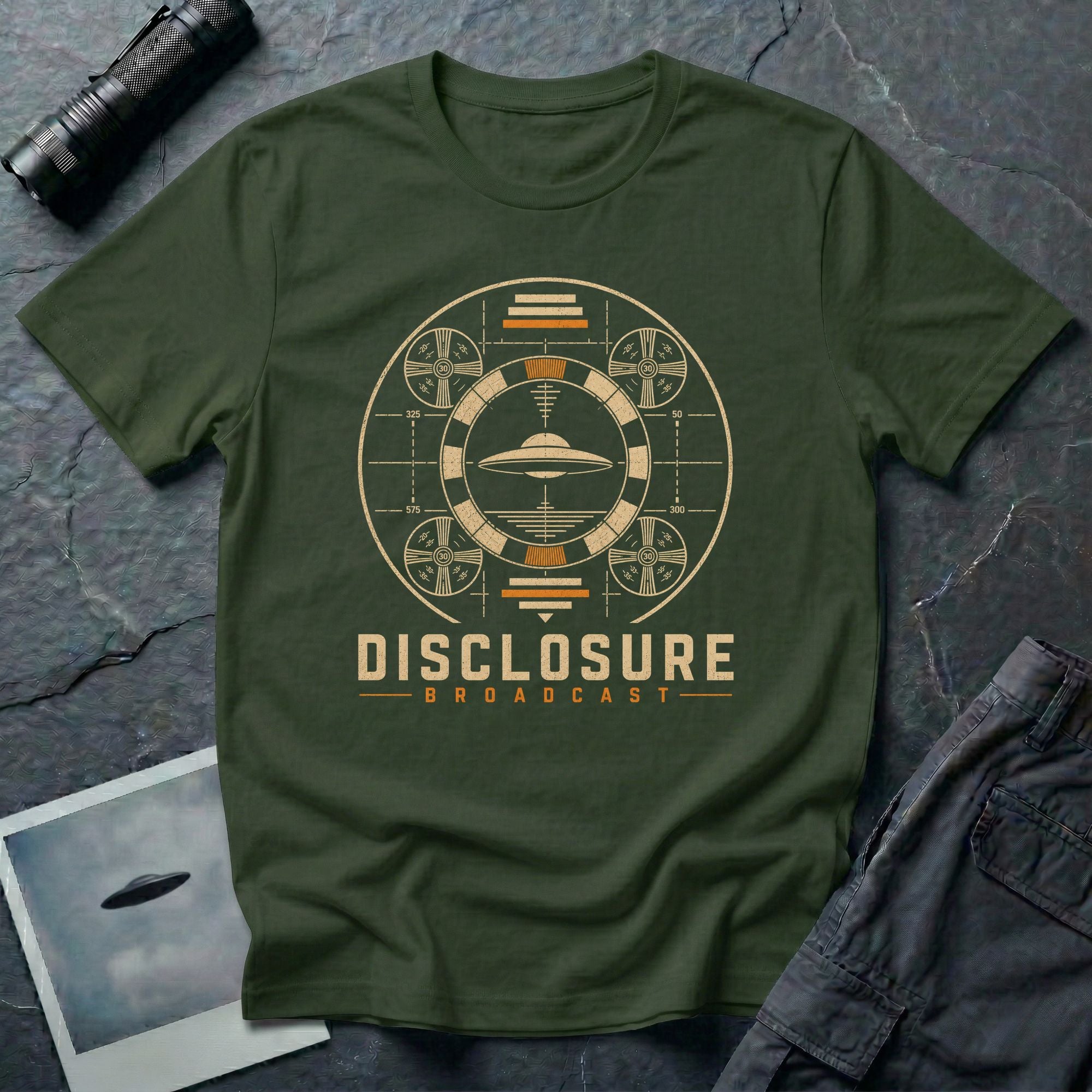 Military green UFO disclosure t-shirt with a flying saucer inside a circular vintage broadcast radar array with orange accents and the words DISCLOSURE BROADCAST