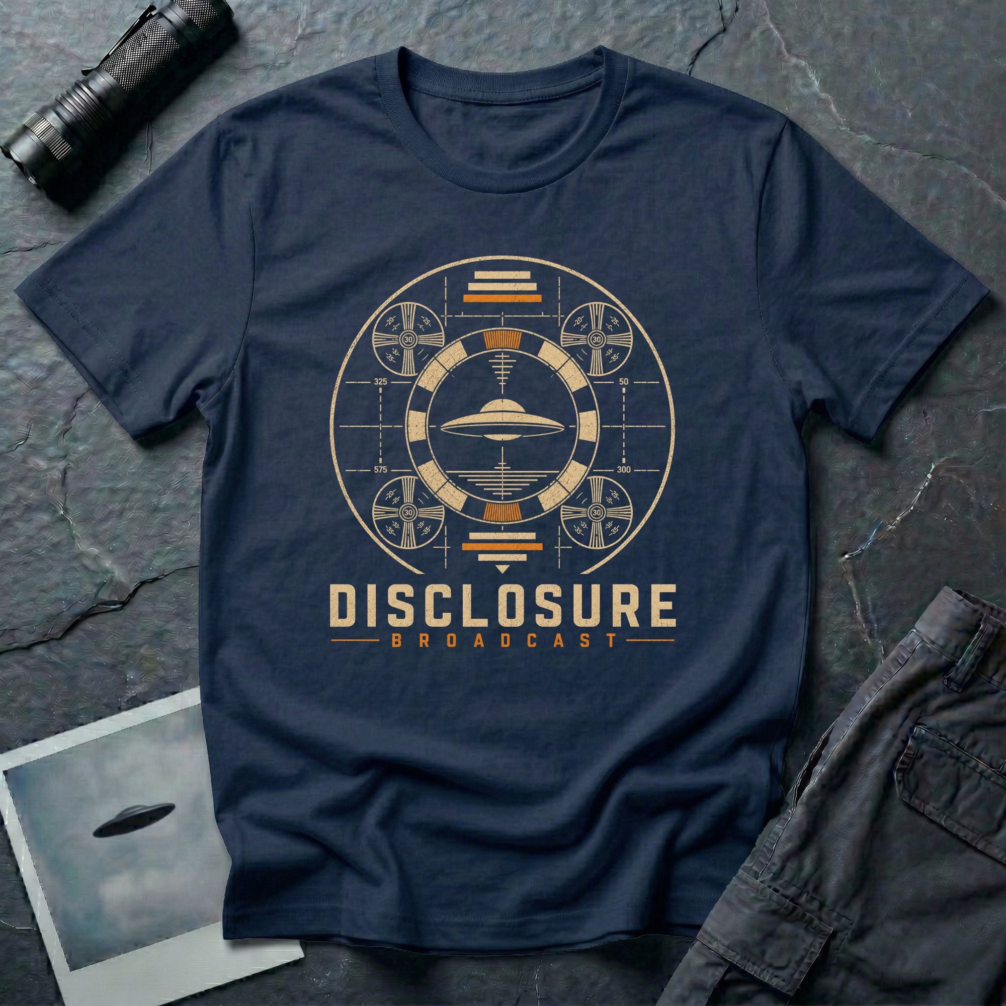 Navy blue UFO disclosure t-shirt with a flying saucer inside a circular vintage broadcast radar array with orange accents and the words DISCLOSURE BROADCAST
