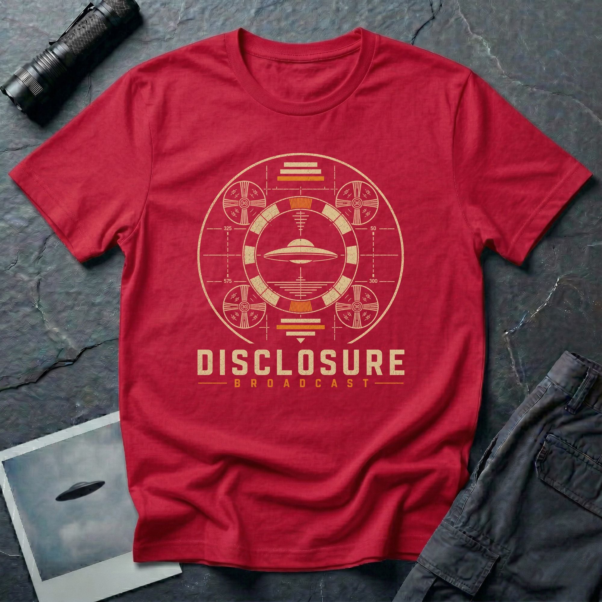 Red UFO disclosure t-shirt with a flying saucer inside a circular vintage broadcast radar array with orange accents and the words DISCLOSURE BROADCAST