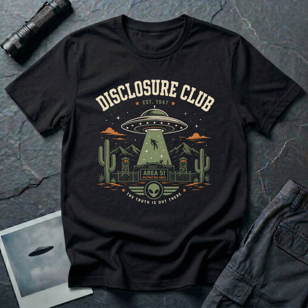 Black t-shirt with vintage collegiate Disclosure Club badge featuring Area 51 facility saucer abduction scene EST 1947 and alien face emblem in cream olive and orange