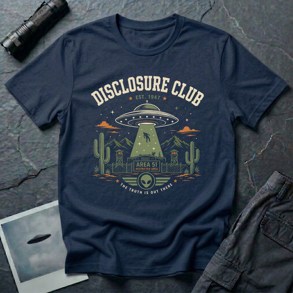 Navy blue t-shirt with vintage collegiate Disclosure Club badge featuring Area 51 facility saucer abduction scene EST 1947 and alien face emblem in cream olive and orange