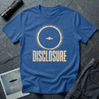 Blue UFO disclosure t-shirt with a flying saucer silhouetted inside a total solar eclipse with radiant corona and the word DISCLOSURE in distressed block letters