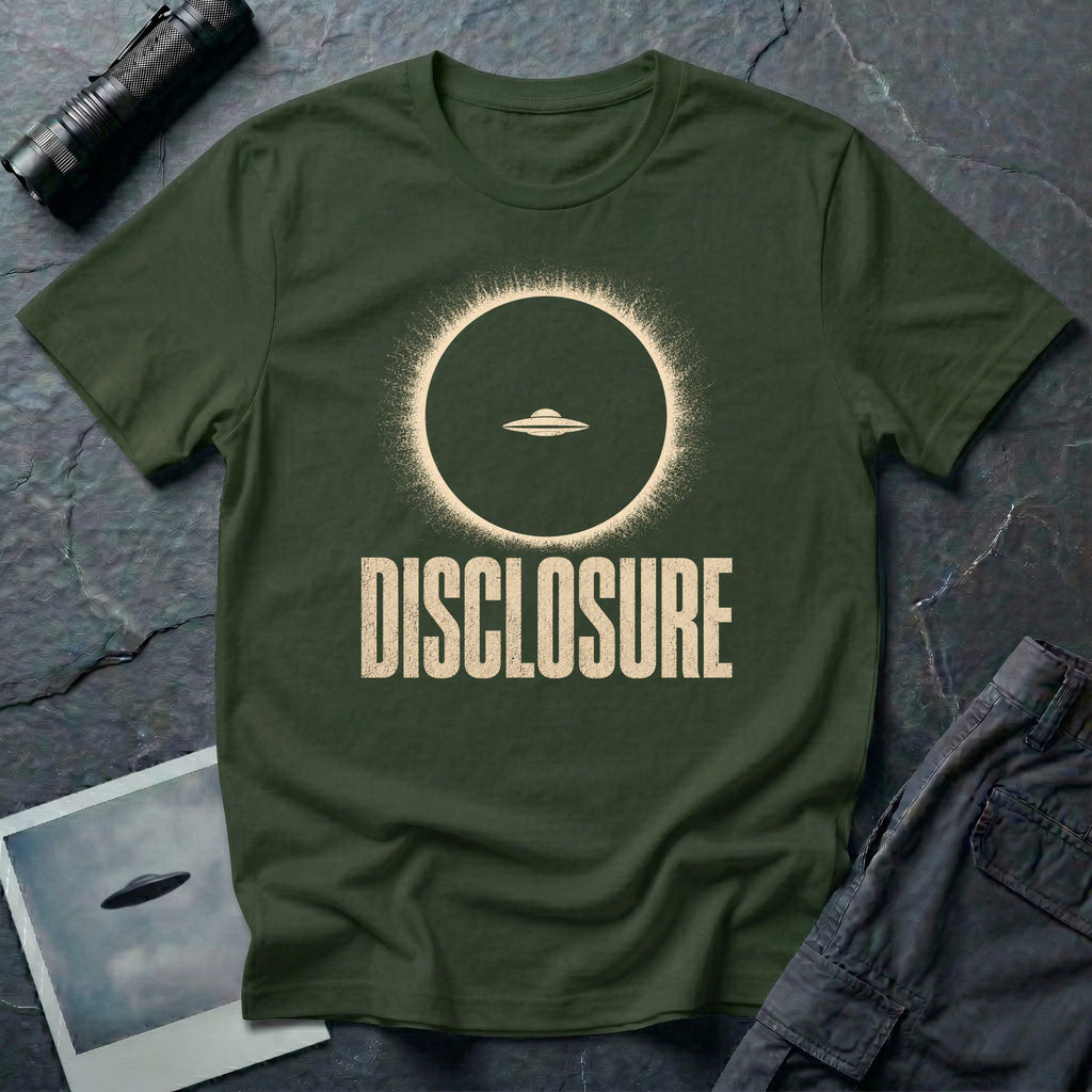 Green UFO disclosure t-shirt with a flying saucer silhouetted inside a total solar eclipse with radiant corona and the word DISCLOSURE in distressed block letters