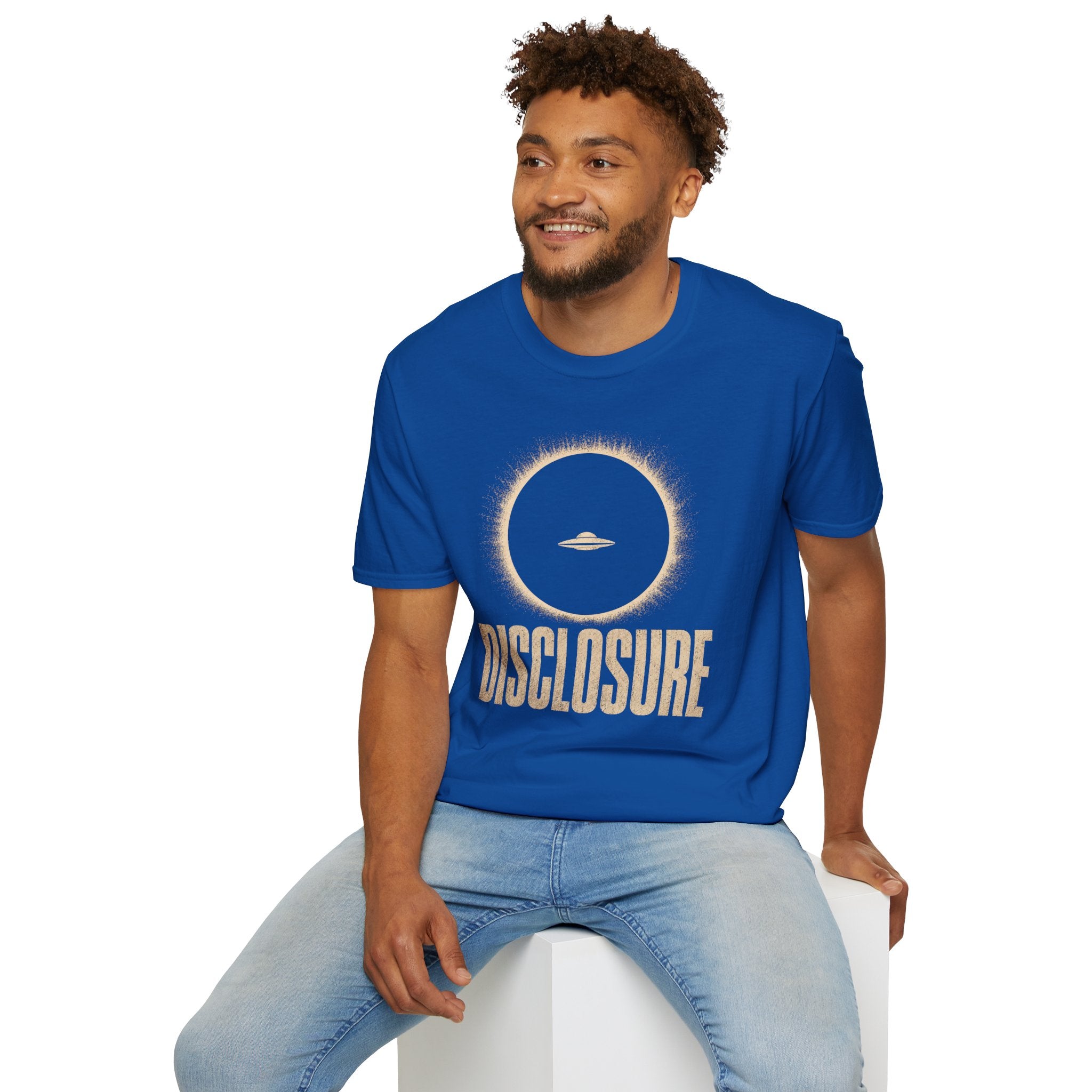 Man wearing blue UFO disclosure t-shirt with a flying saucer silhouetted inside a total solar eclipse with radiant corona and the word DISCLOSURE in distressed block letters