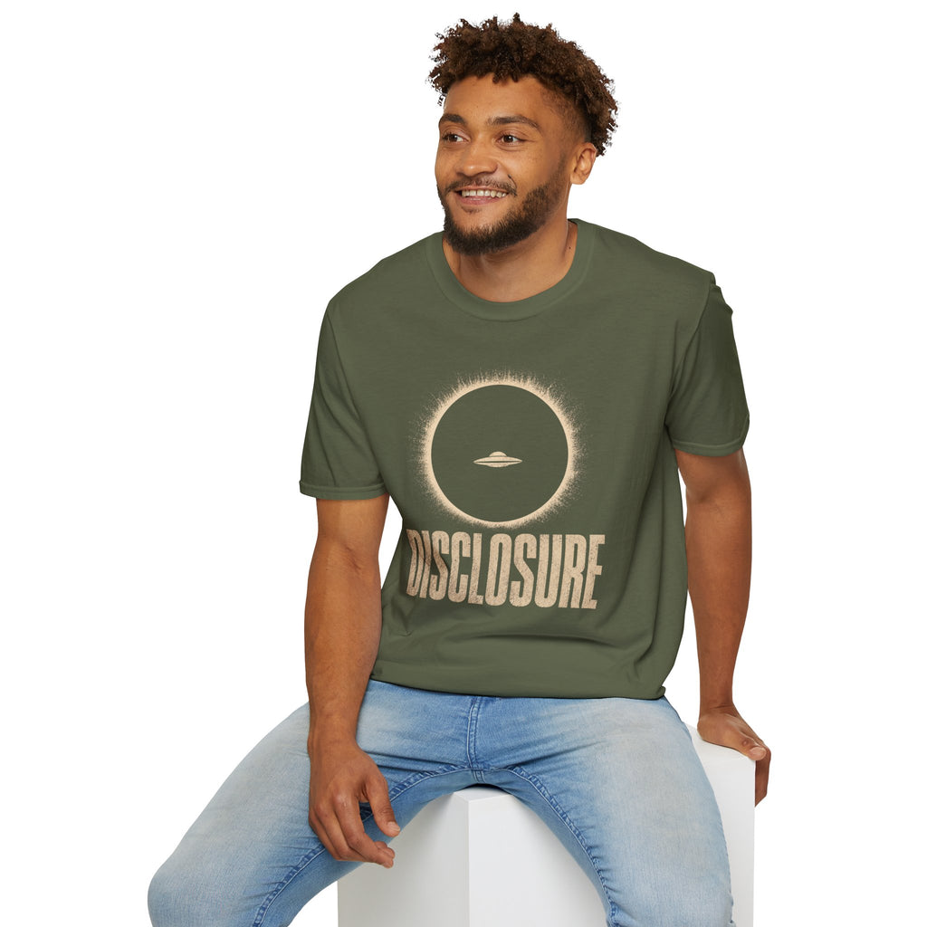 Man wearing green UFO disclosure t-shirt with a flying saucer silhouetted inside a total solar eclipse with radiant corona and the word DISCLOSURE in distressed block letters