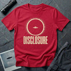 Red UFO disclosure t-shirt with a flying saucer silhouetted inside a total solar eclipse with radiant corona and the word DISCLOSURE in distressed block letters
