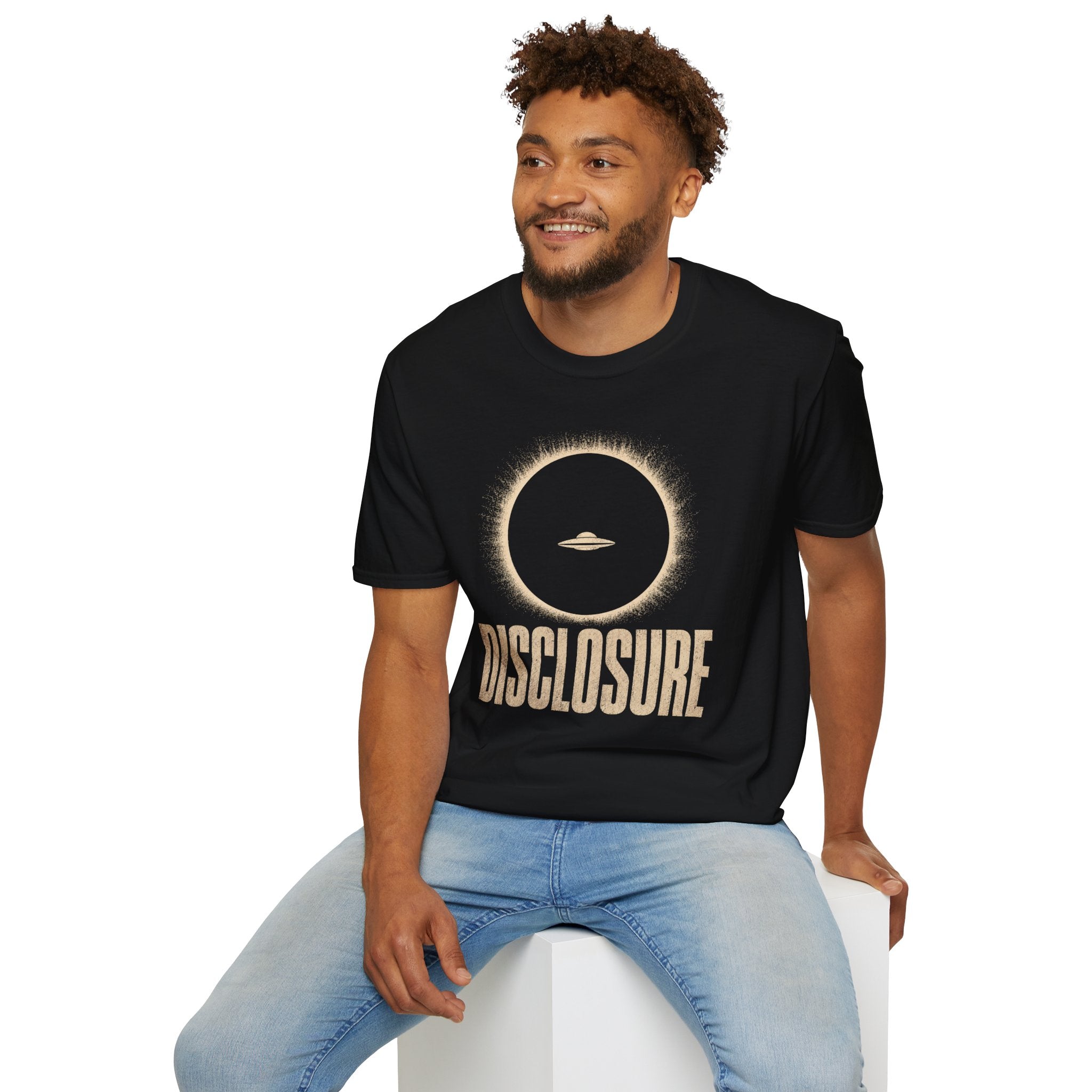 Man wearing black UFO disclosure t-shirt with a flying saucer silhouetted inside a total solar eclipse with radiant corona and the word DISCLOSURE in distressed block letters