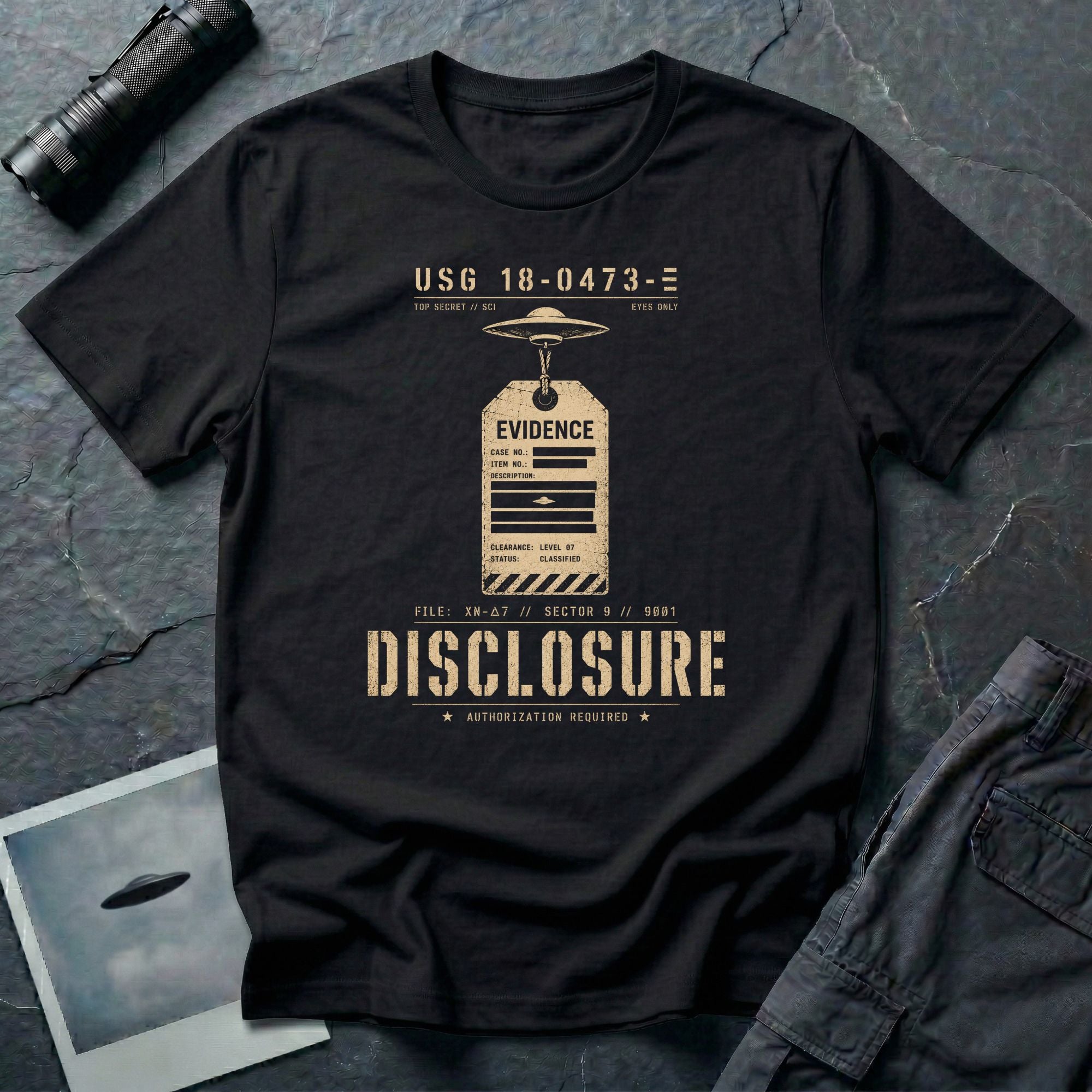 Black UFO disclosure t-shirt with a classified evidence tag hanging from a flying saucer showing TOP SECRET SCI EYES ONLY and the word DISCLOSURE in distressed stencil type