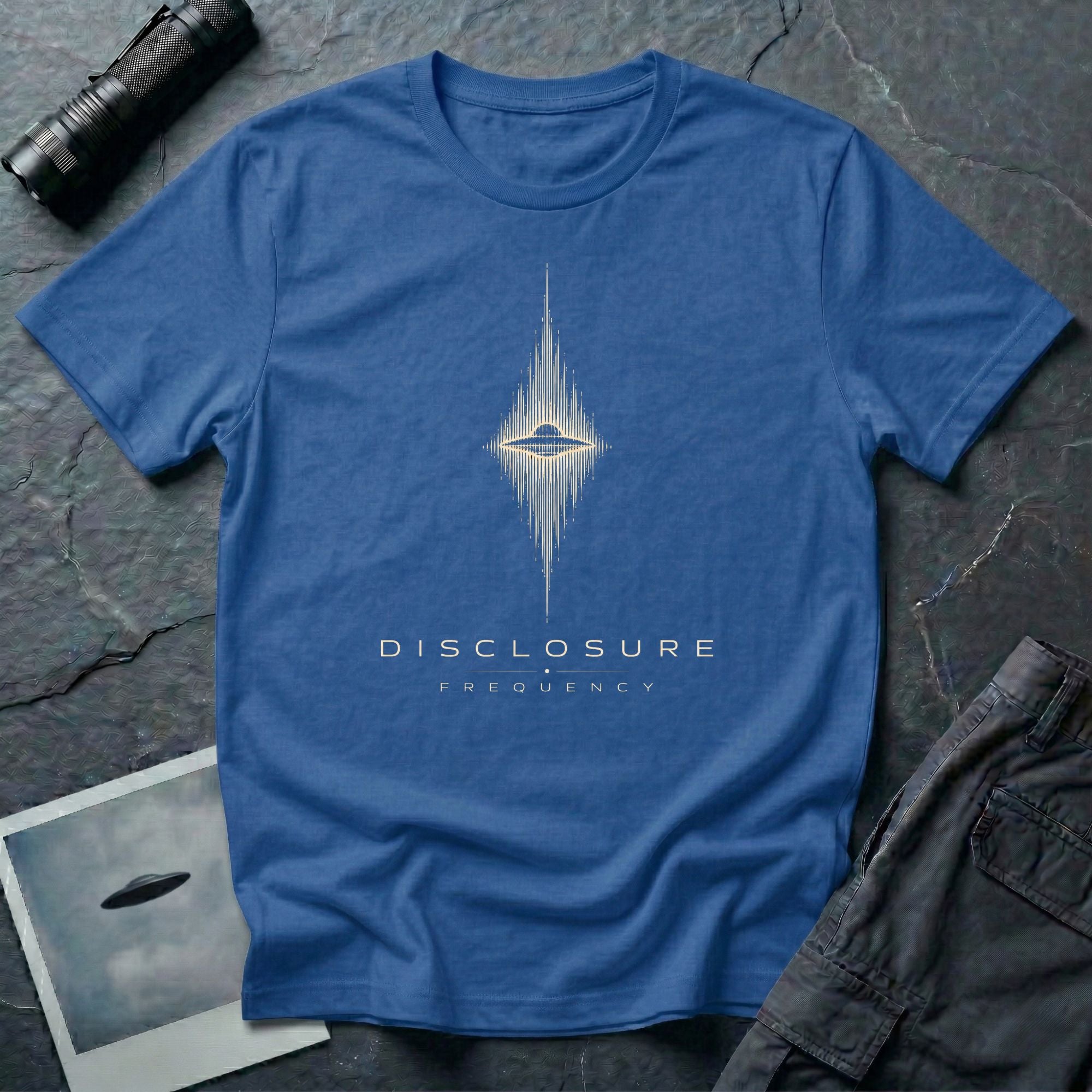 Royal blue UFO disclosure t-shirt with a flying saucer at the centre of a diamond-shaped frequency waveform in white with the words DISCLOSURE FREQUENCY beneath