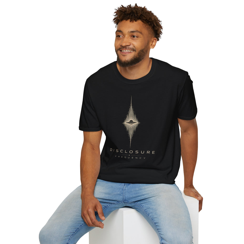 Man wearing black UFO disclosure t-shirt with a flying saucer at the centre of a diamond-shaped frequency waveform in white with the words DISCLOSURE FREQUENCY beneath