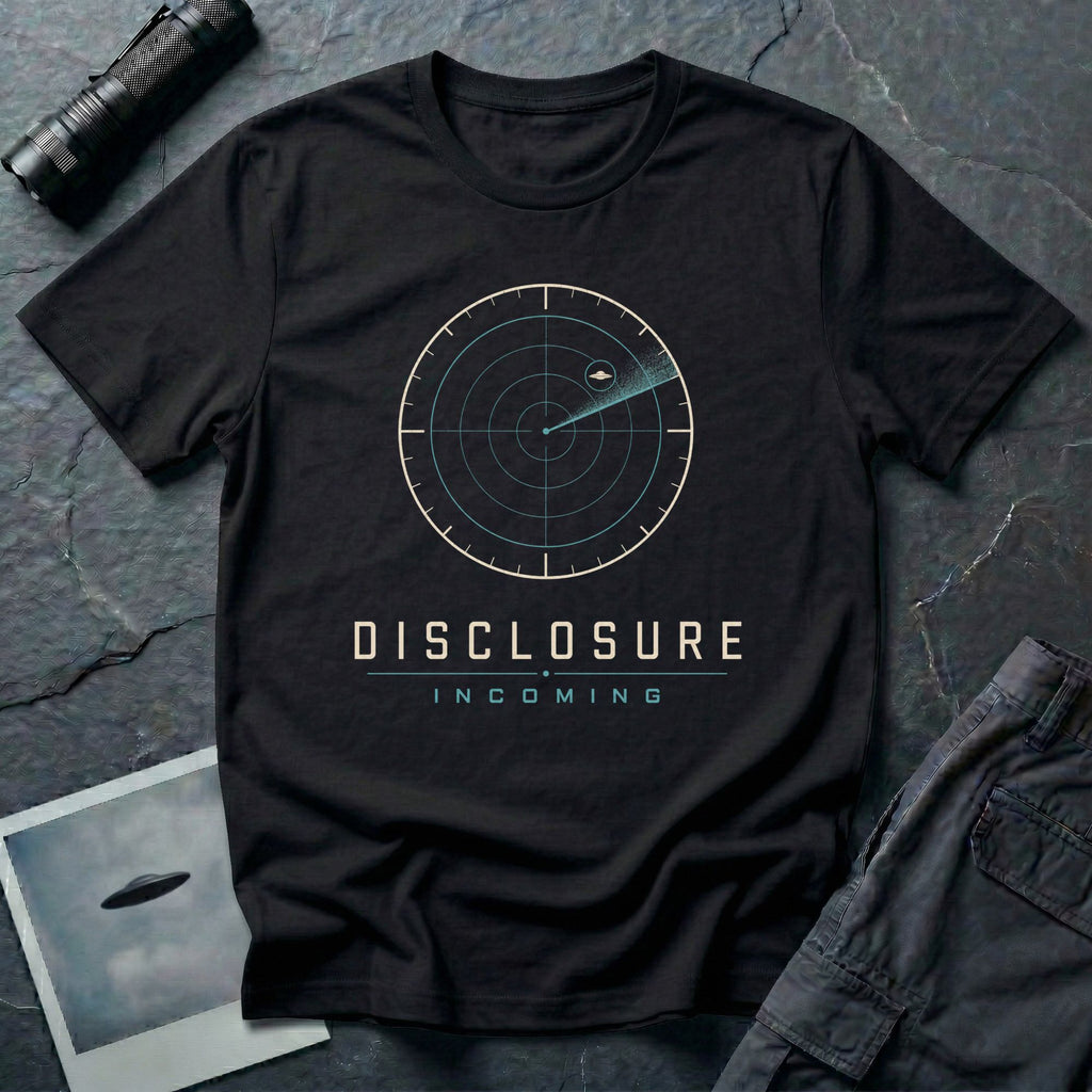 Black UFO disclosure t-shirt with a classic radar screen showing a flying saucer tracked in the upper quadrant with a sweep trail and the words DISCLOSURE INCOMING in cream and cyan