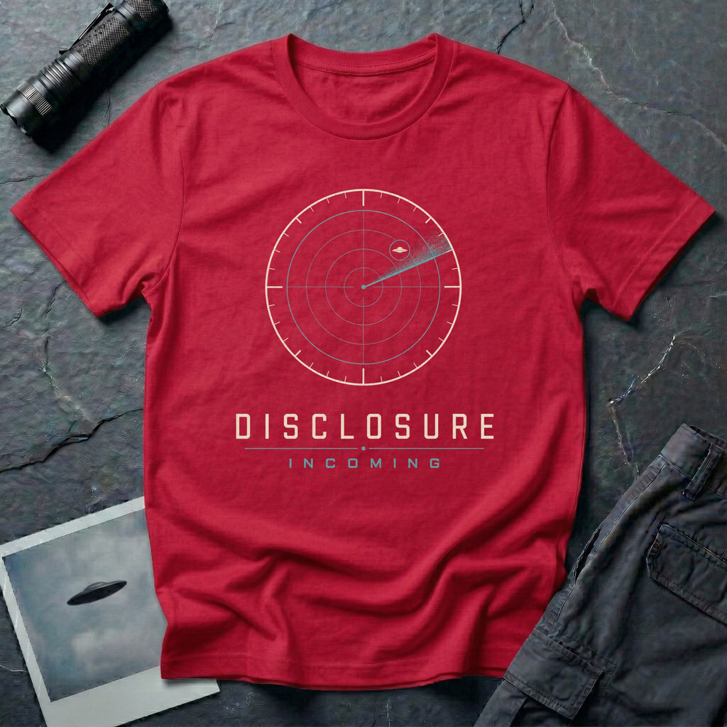 Red UFO disclosure t-shirt with a classic radar screen showing a flying saucer tracked in the upper quadrant with a sweep trail and the words DISCLOSURE INCOMING in cream and cyan