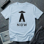 Light blue UFO disclosure t-shirt with a flying saucer beaming the US Capitol building in black with the words DISCLOSURE IS NOW