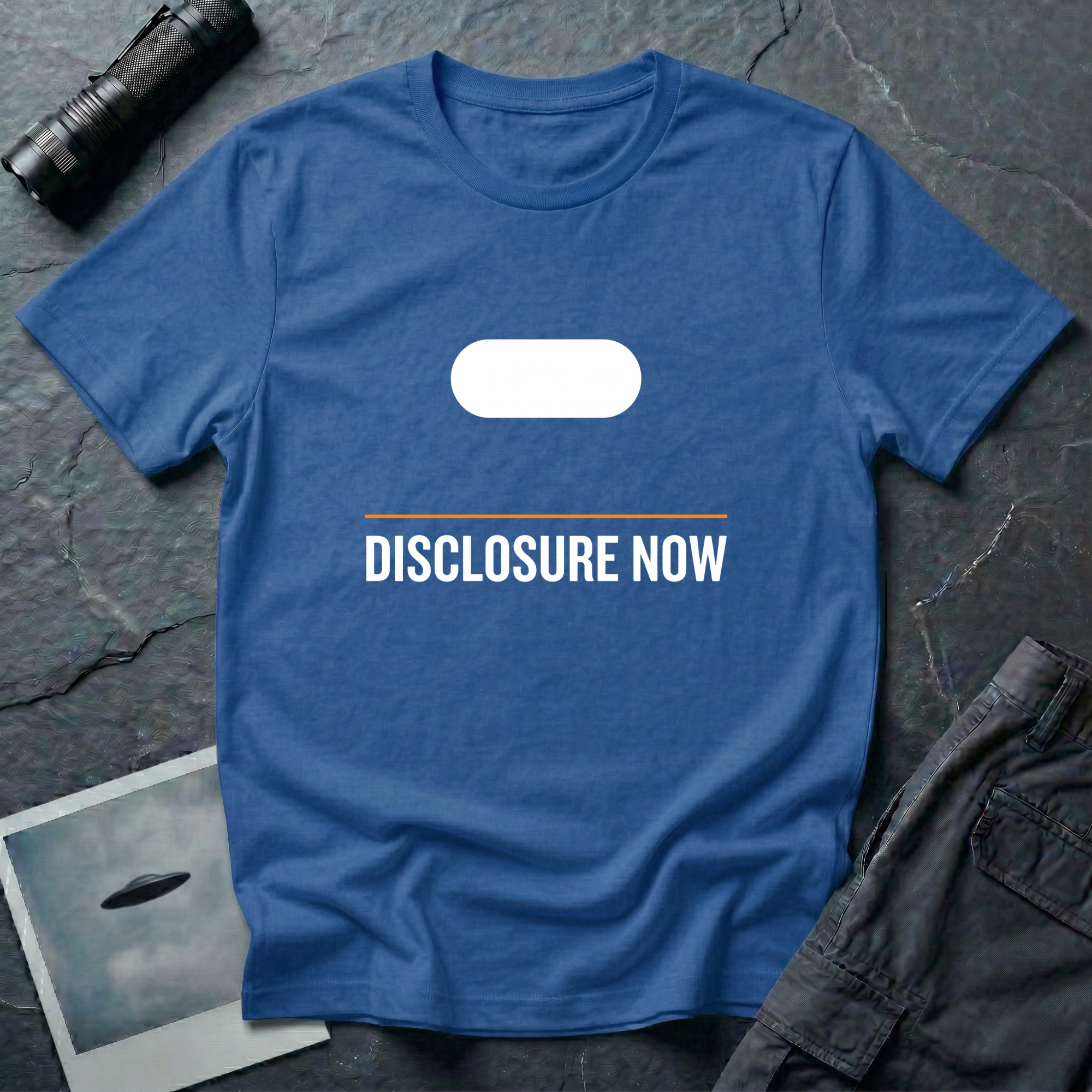 Black t-shirt with white Tic Tac UAP silhouette above an orange horizontal rule and DISCLOSURE NOW in bold white caps