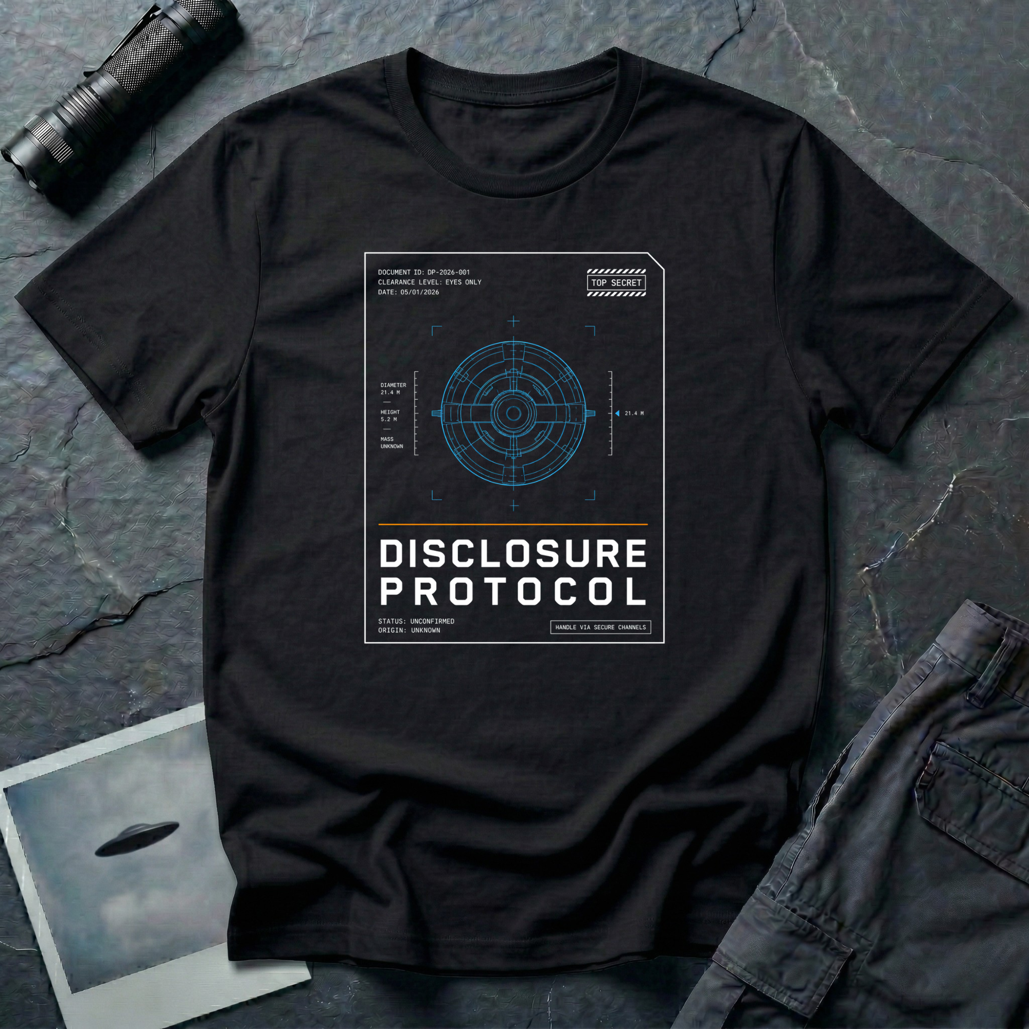 Black t-shirt with a blue technical wireframe of a circular UFO inside a white "Top Secret" classified document frame with the text DISCLOSURE PROTOCOL.