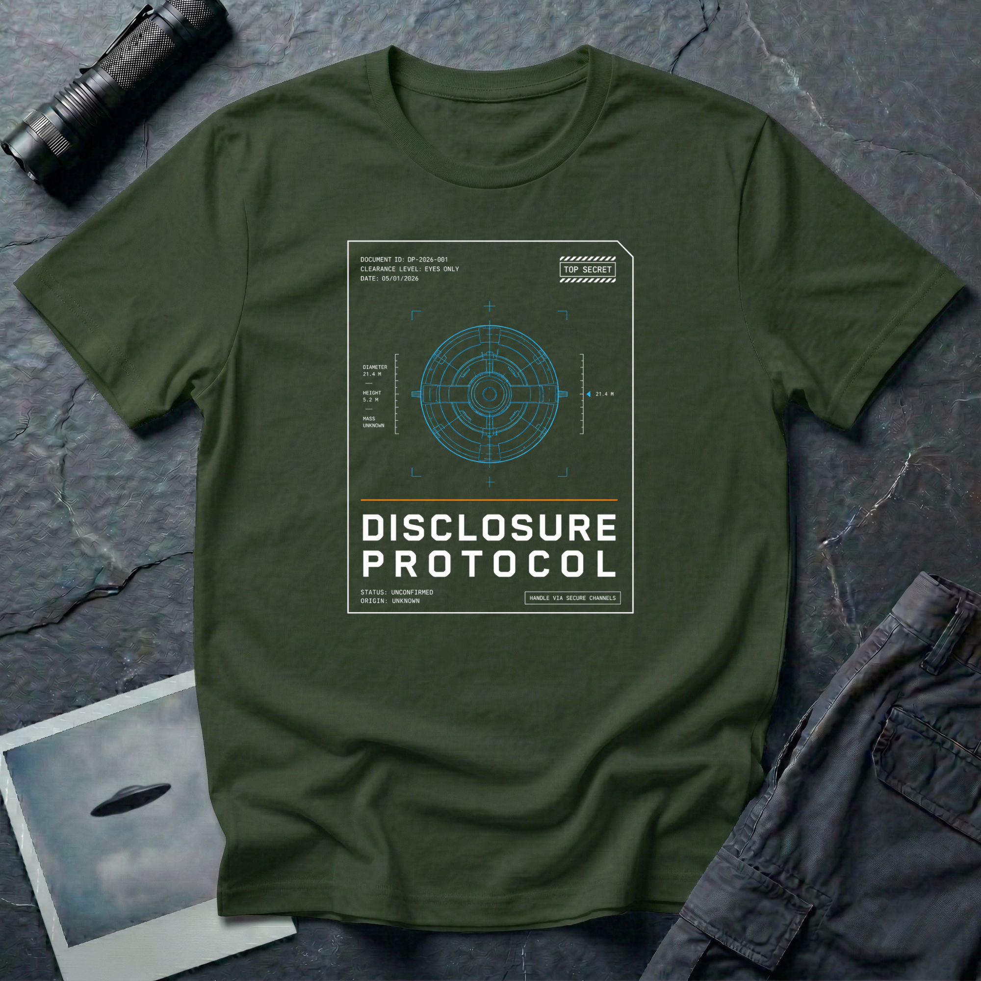 Military Green t-shirt with a blue technical wireframe of a circular UFO inside a white "Top Secret" classified document frame with the text DISCLOSURE PROTOCOL.