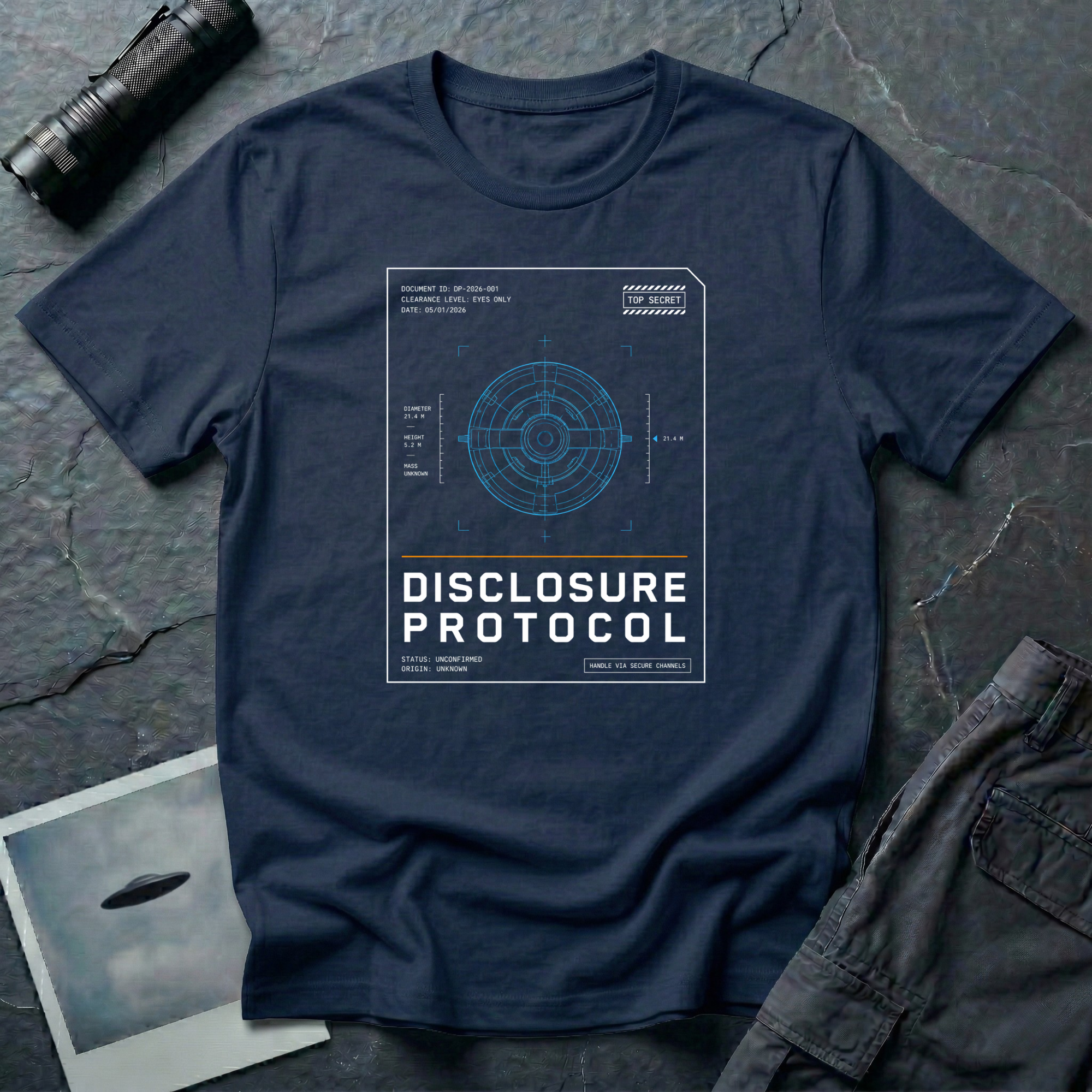 Navy t-shirt with a blue technical wireframe of a circular UFO inside a white "Top Secret" classified document frame with the text DISCLOSURE PROTOCOL.