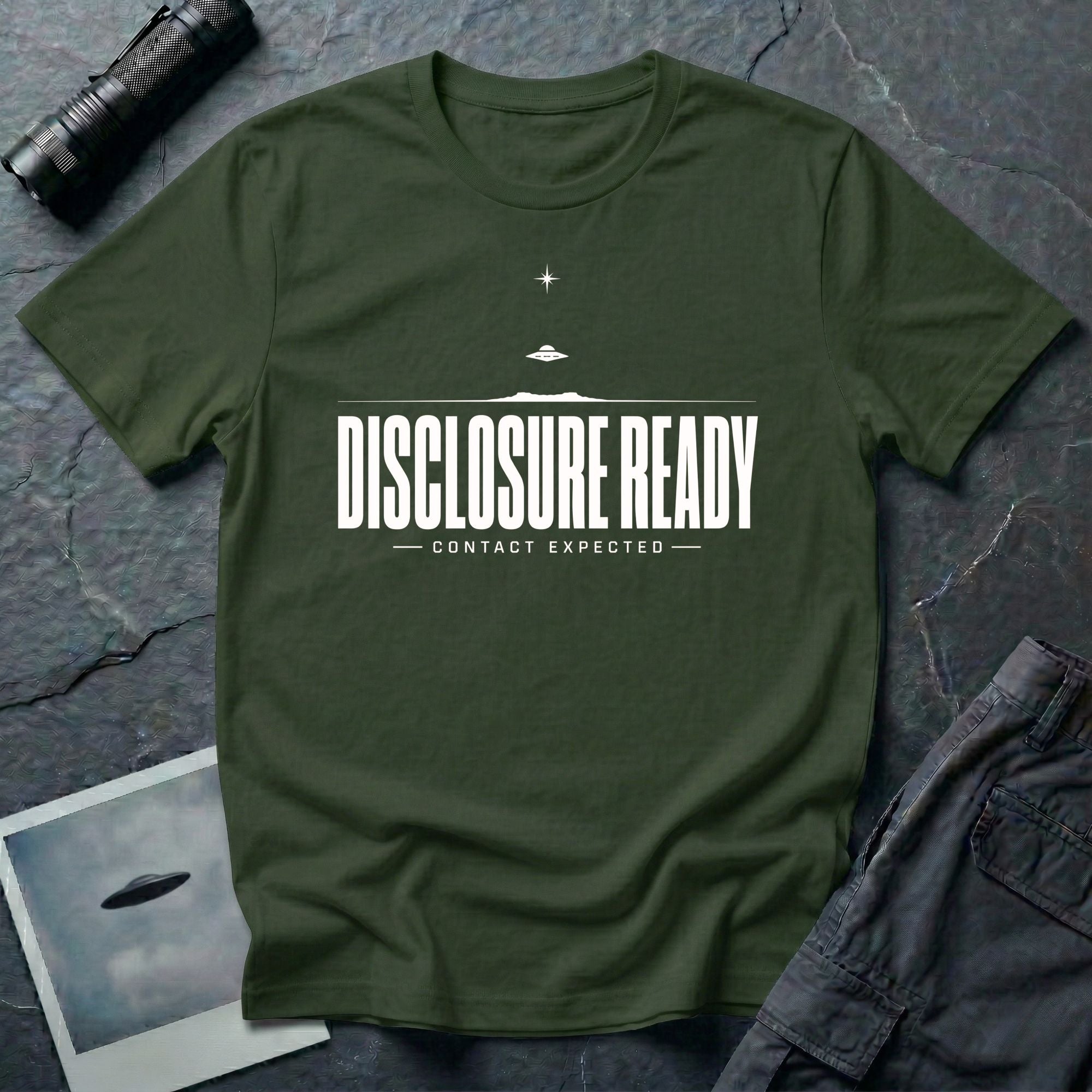 Green UFO disclosure t-shirt with bold block letters reading DISCLOSURE READY and subtitle CONTACT EXPECTED with a small flying saucer above the horizon in white