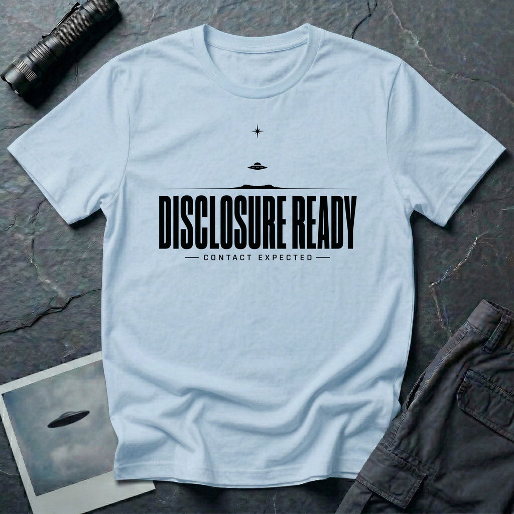 Light blue UFO disclosure t-shirt with bold block letters reading DISCLOSURE READY and subtitle CONTACT EXPECTED with a small flying saucer above the horizon in black