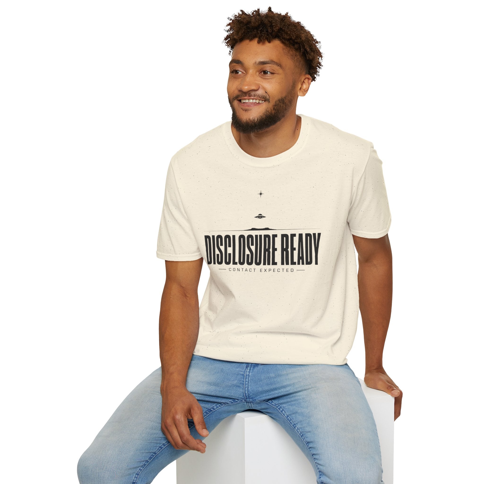 Man wearing natural UFO disclosure t-shirt with bold block letters reading DISCLOSURE READY and subtitle CONTACT EXPECTED with a small flying saucer above the horizon in black