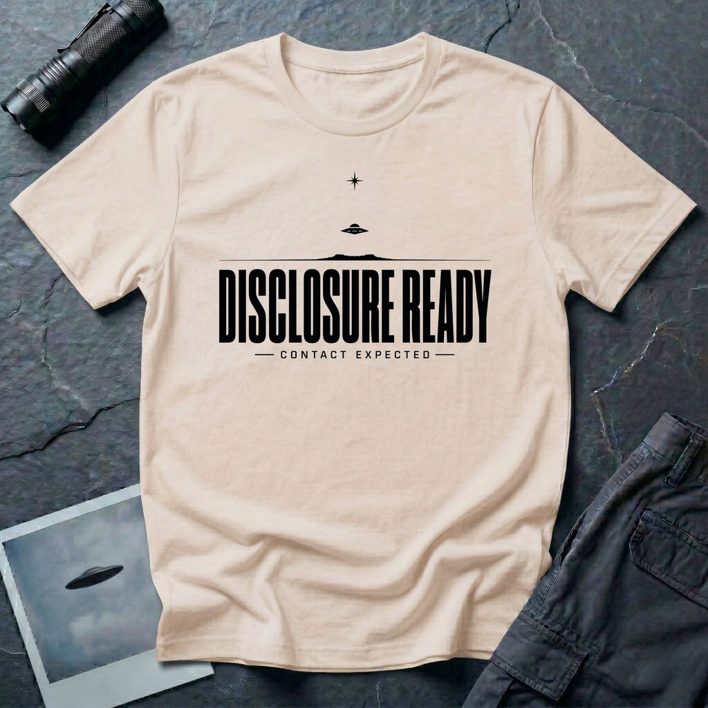 Natural UFO disclosure t-shirt with bold block letters reading DISCLOSURE READY and subtitle CONTACT EXPECTED with a small flying saucer above the horizon in black