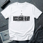 White UFO disclosure t-shirt with bold block letters reading DISCLOSURE READY and subtitle CONTACT EXPECTED with a small flying saucer above the horizon in black