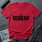 Red UFO disclosure t-shirt with bold block letters reading DISCLOSURE READY and subtitle CONTACT EXPECTED with a small flying saucer above the horizon in black