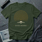 Green UFO disclosure t-shirt with a flying saucer broadcasting concentric signal arcs upward in orange and cream with the word DISCLOSURE beneath