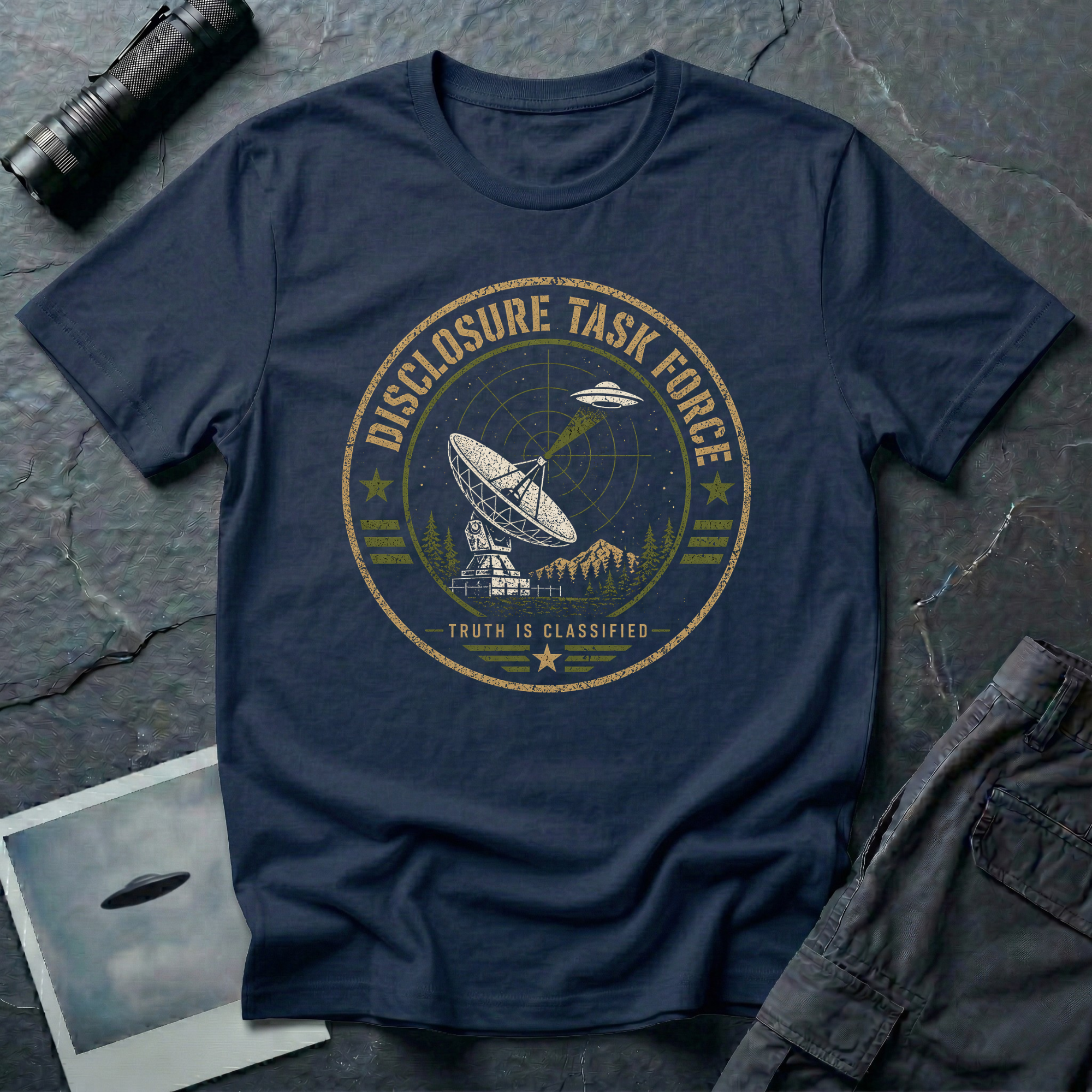 Navy blue t-shirt with a circular military-style badge showing a satellite dish pointed at a saucer UFO and the text DISCLOSURE TASK FORCE.