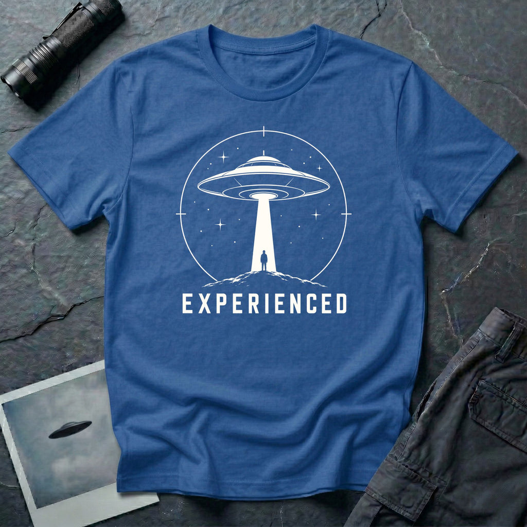 Experienced UFO T-shirt with a lone figure standing beneath the beam of a flying saucer inside a circular night-sky design. Royal blue tee