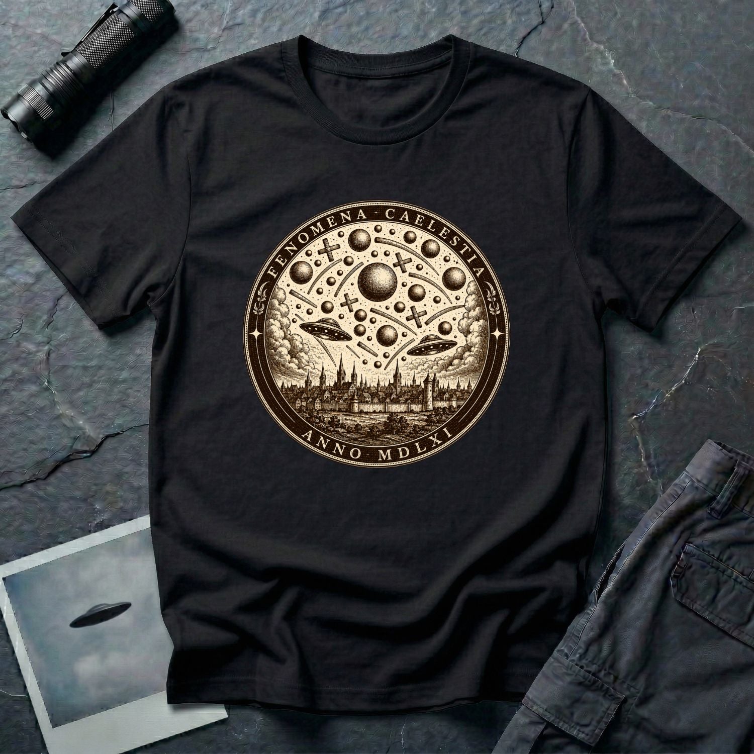 Black t-shirt with a sepia engraving medallion depicting the 1561 Nuremberg UFO phenomenon with craft, spheres and the words FENOMENA CAELESTIA ANNO MDLXI