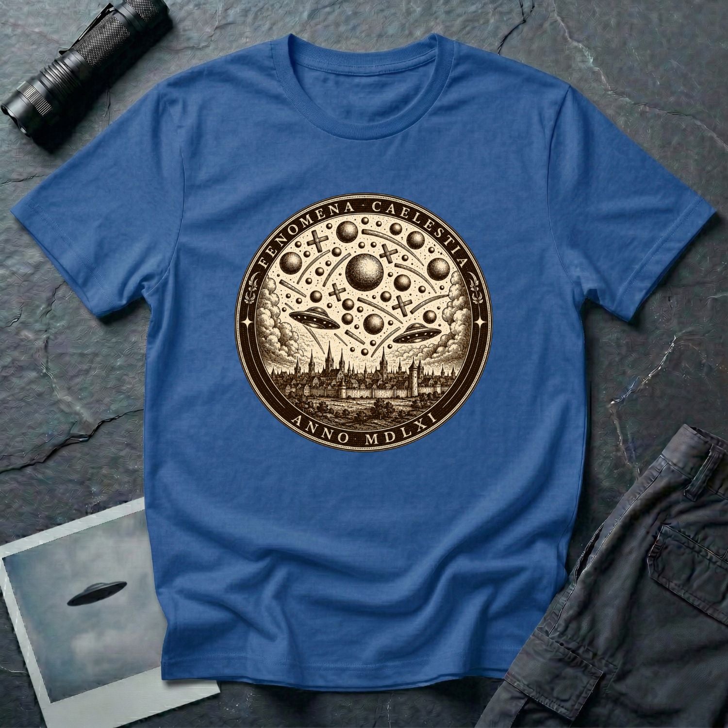 Royal blue t-shirt with a sepia engraving medallion depicting the 1561 Nuremberg UFO phenomenon with craft, spheres and the words FENOMENA CAELESTIA ANNO MDLXI