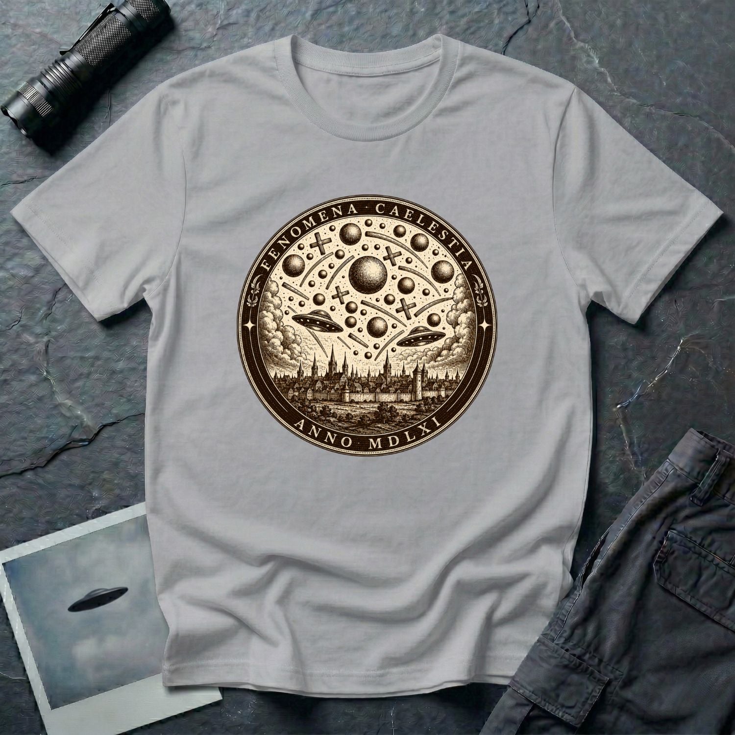 Grey t-shirt with a sepia engraving medallion depicting the 1561 Nuremberg UFO phenomenon with craft, spheres and the words FENOMENA CAELESTIA ANNO MDLXI