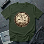 Military green t-shirt with a sepia engraving medallion depicting the 1561 Nuremberg UFO phenomenon with craft, spheres and the words FENOMENA CAELESTIA ANNO MDLXI