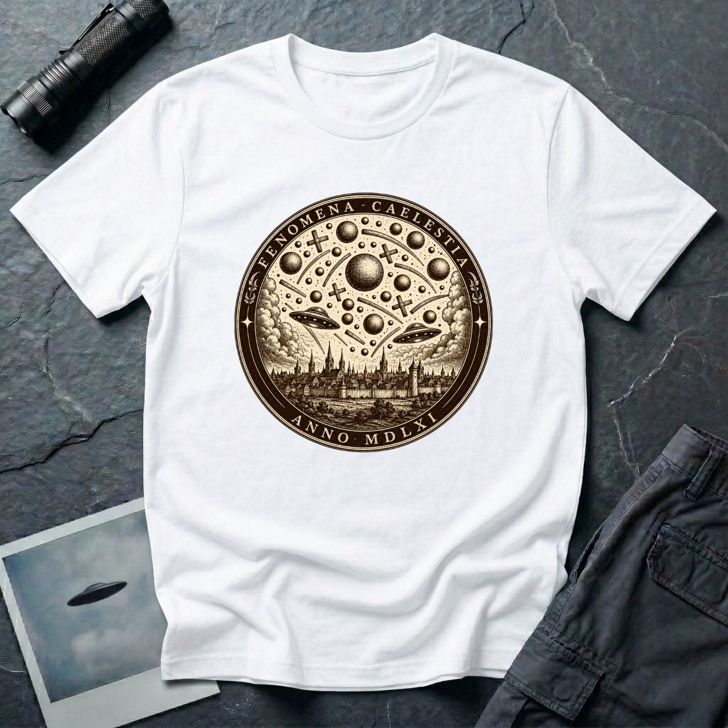White t-shirt with a sepia engraving medallion depicting the 1561 Nuremberg UFO phenomenon with craft, spheres and the words FENOMENA CAELESTIA ANNO MDLXI