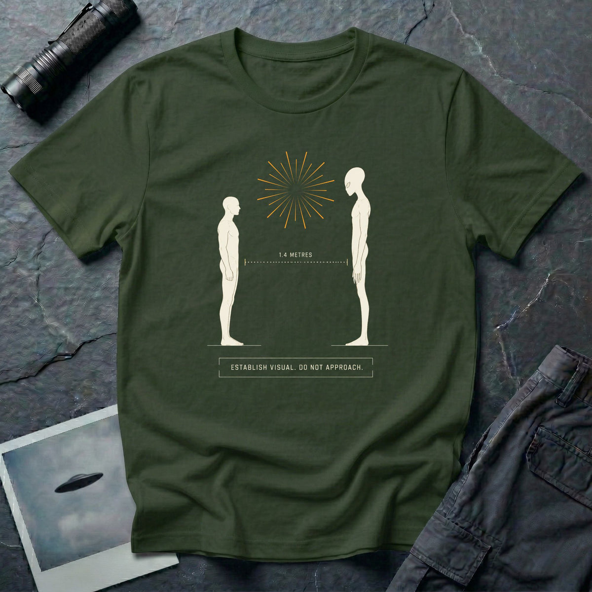 Green t-shirt with human and alien figures facing each other at a measured 1.4 metre distance under a starburst, with establish visual do not approach caption