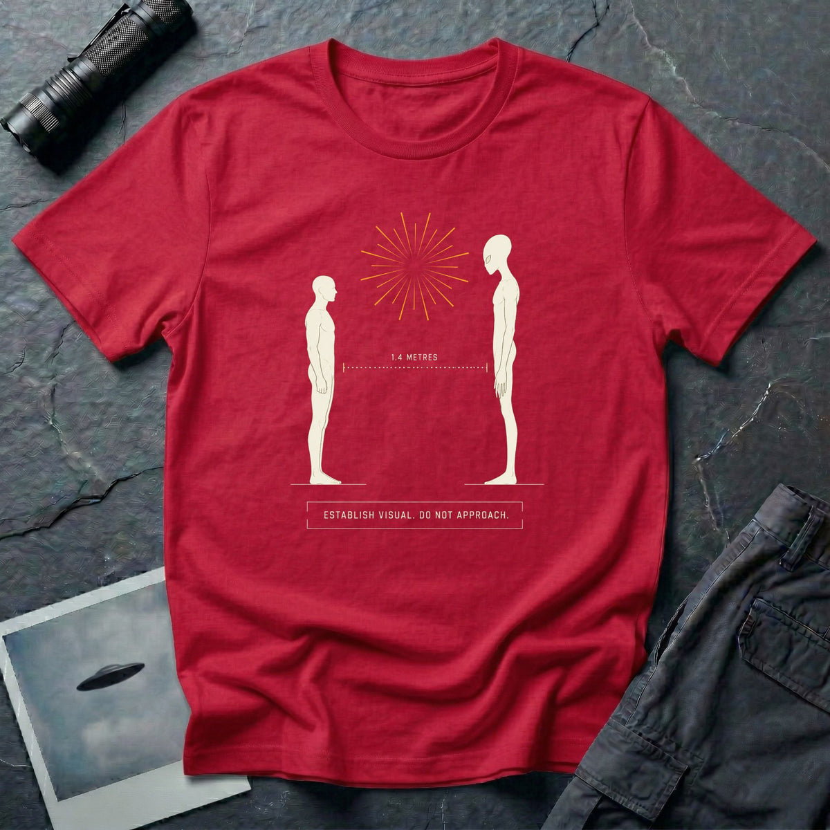 Red t-shirt with human and alien figures facing each other at a measured 1.4 metre distance under a starburst, with establish visual do not approach caption